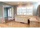 Bathroom with tile flooring, and white cabinetry below a set of windows at 8659 E Kenyon Ave, Denver, CO 80237