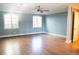 Bedroom features hardwood floors, two windows and neutral walls at 8659 E Kenyon Ave, Denver, CO 80237