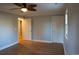 This bright bedroom features hardwood floors and two doors, one is partially opened at 8659 E Kenyon Ave, Denver, CO 80237