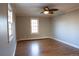 This bright bedroom features hardwood floors, neutral walls and two large windows at 8659 E Kenyon Ave, Denver, CO 80237