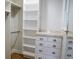 Walk-in closet with custom shelves, drawers and rails providing ample storage space at 8659 E Kenyon Ave, Denver, CO 80237