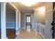 Inviting foyer with hardwood floors, trim, and stairway creating a warm and welcoming atmosphere at 8659 E Kenyon Ave, Denver, CO 80237