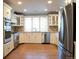 Bright kitchen with stainless steel appliances, granite countertops, large refrigerator, and ample cabinet space at 8659 E Kenyon Ave, Denver, CO 80237