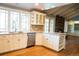Bright eat-in kitchen features white cabinets, granite countertops, stainless appliances, and a large picture window at 8659 E Kenyon Ave, Denver, CO 80237
