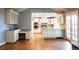 Bright kitchen featuring stainless steel appliances, custom cabinetry, and hardwood floors at 8659 E Kenyon Ave, Denver, CO 80237