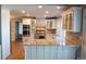 Gourmet kitchen with custom cabinets, stainless steel appliances, and granite countertops at 8659 E Kenyon Ave, Denver, CO 80237