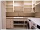 Laundry room featuring washer, dryer, sink and storage cabinets at 8659 E Kenyon Ave, Denver, CO 80237