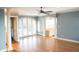 Spacious living room featuring hardwood floors, white columns and french doors at 8659 E Kenyon Ave, Denver, CO 80237