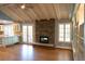 Inviting living area with a stone fireplace, hardwood floors, and ample natural light at 8659 E Kenyon Ave, Denver, CO 80237