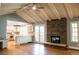 Spacious living room featuring a stone fireplace and an open kitchen at 8659 E Kenyon Ave, Denver, CO 80237