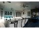 Covered patio with outdoor seating and a stone fireplace at 8659 E Kenyon Ave, Denver, CO 80237