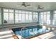 Indoor pool with ceiling fans surrounded by many windows letting in light at 8659 E Kenyon Ave, Denver, CO 80237