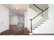 Bright entryway with hardwood floors and staircase with white railing at 335 Josephine St # A, Denver, CO 80206