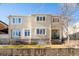 Light beige two-story home with a brick wall and landscaping at 335 Josephine St # A, Denver, CO 80206