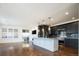 Spacious kitchen with dark cabinetry, granite island, and hardwood floors at 335 Josephine St # A, Denver, CO 80206