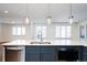 Kitchen island with granite countertop and stainless steel dishwasher at 335 Josephine St # A, Denver, CO 80206