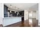 Modern kitchen featuring dark gray cabinets, granite counters, and stainless steel appliances at 335 Josephine St # A, Denver, CO 80206
