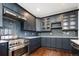 Modern kitchen with dark gray cabinets and a herringbone tile backsplash at 335 Josephine St # A, Denver, CO 80206