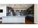 Modern kitchen with dark gray cabinets, granite countertops and stainless steel appliances at 335 Josephine St # A, Denver, CO 80206