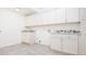 Laundry room with white cabinets and granite countertops at 335 Josephine St # A, Denver, CO 80206