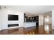 Living room with hardwood floors, fireplace, and kitchen view at 335 Josephine St # A, Denver, CO 80206
