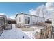 Fenced backyard with grey siding, sliding glass doors, and a gravel area at 262 Apache Pl, Brighton, CO 80603