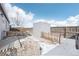 Fenced backyard featuring a storage shed and a gravel area at 262 Apache Pl, Brighton, CO 80603