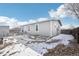 Exterior view of the home and backyard featuring grey siding and a wooden fence at 262 Apache Pl, Brighton, CO 80603