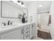 Modern bathroom featuring double sinks, a large mirror, and a shower-tub combo at 262 Apache Pl, Brighton, CO 80603