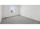 Neutral bedroom with gray carpet and a bright window at 262 Apache Pl, Brighton, CO 80603