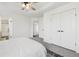 Bright bedroom featuring a ceiling fan, plush carpeting, and ensuite bath at 262 Apache Pl, Brighton, CO 80603