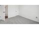 Empty bedroom featuring light gray carpet and a white door at 262 Apache Pl, Brighton, CO 80603