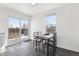 Bright dining area featuring a dark table and access to the backyard through sliding glass doors at 262 Apache Pl, Brighton, CO 80603