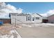 Cozy home with mature trees, drought resistant landscape, and a large concrete driveway at 262 Apache Pl, Brighton, CO 80603