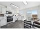 Bright kitchen with modern appliances, white cabinetry, and adjacent dining area with sliding glass doors at 262 Apache Pl, Brighton, CO 80603