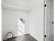 Empty laundry room with white shelving and dark vinyl floors at 262 Apache Pl, Brighton, CO 80603