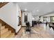 An open basement area with a bar, pool table (out of view), and comfortable seating area at 8246 Raphael Ln, Littleton, CO 80125