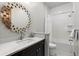 Bathroom featuring modern fixtures, a large decorative mirror, and a shower-tub combination at 8246 Raphael Ln, Littleton, CO 80125