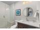 Bathroom featuring a glass enclosed shower and a modern vanity with countertop at 8246 Raphael Ln, Littleton, CO 80125