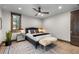 Cozy bedroom with a ceiling fan, wood trim, and a comfortable bed and seating at 8246 Raphael Ln, Littleton, CO 80125