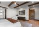 Comfortable bedroom features wood beam accents, stylish decor, and ample natural light at 8246 Raphael Ln, Littleton, CO 80125