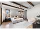Spacious bedroom with wood-beamed ceiling and modern furnishings at 8246 Raphael Ln, Littleton, CO 80125