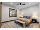 Bedroom with a large window, a ceiling fan, and a decorative rug at 8246 Raphael Ln, Littleton, CO 80125