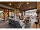 Relaxing covered deck featuring stone pillars, outdoor furniture, and picturesque views at 8246 Raphael Ln, Littleton, CO 80125