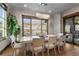 Elegant dining room with views of the exterior landscape through a large window at 8246 Raphael Ln, Littleton, CO 80125