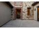 Close-up of the front door featuring stone and brick detailing at 8246 Raphael Ln, Littleton, CO 80125