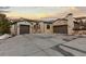 Charming front exterior with two-car garage, stone accents, and spacious driveway at 8246 Raphael Ln, Littleton, CO 80125