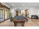 A game room with pool table, bar, and access to the outdoor patio, perfect for entertaining at 8246 Raphael Ln, Littleton, CO 80125