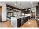 Open kitchen with island and stone countertops adjacent to the living room at 8246 Raphael Ln, Littleton, CO 80125