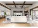 Spacious living room with stone fireplace, wooden beam ceiling, and open floor plan to the kitchen at 8246 Raphael Ln, Littleton, CO 80125